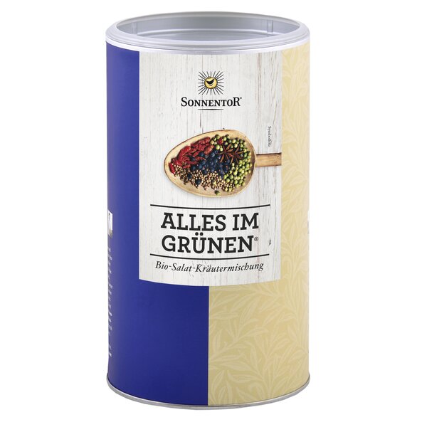 A photo of a big jumbo spice tin All in Green salad seasoning. On the tin is a wooden spoon with many spices depicted.